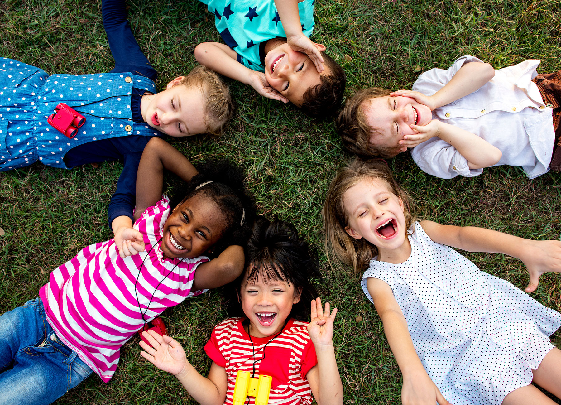 Group of children on a lawn, smiling